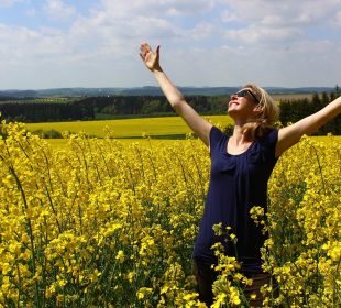 a woman with her hands in the air in a form of gratitude