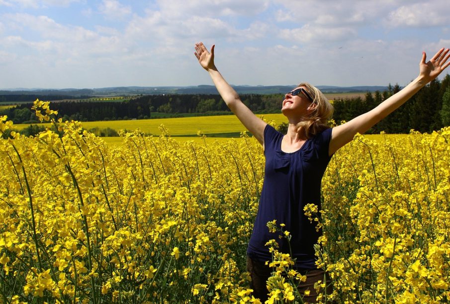 a woman with her hands in the air in a form of gratitude