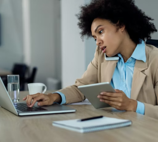 a lady in an office answering a call and typing