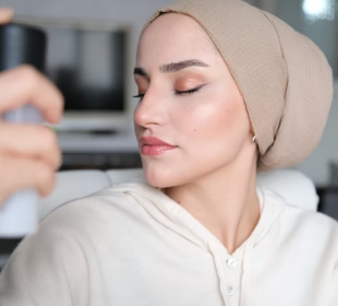 Woman applying setting spray after full makeup routine