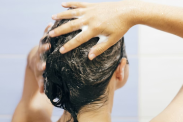 Woman applying scalp scrub during a scalp detox routine