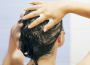 Woman applying scalp scrub during a scalp detox routine