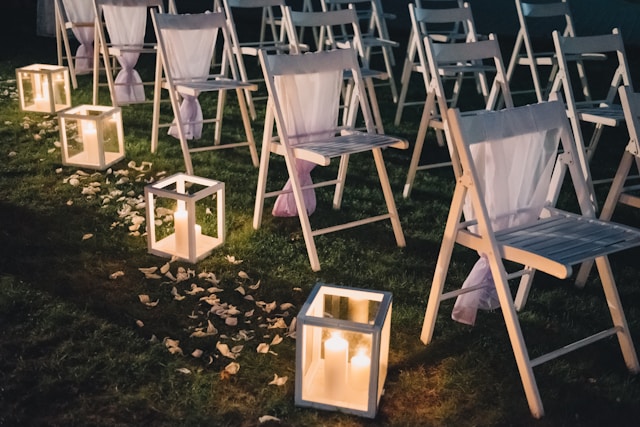 Wedding aisle decorated with lanterns and candlelight.