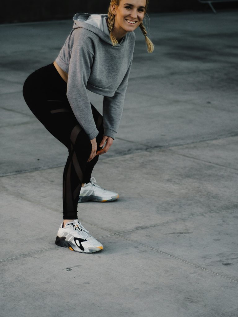 a model on an athleisure style with a fitting leggings and crop top