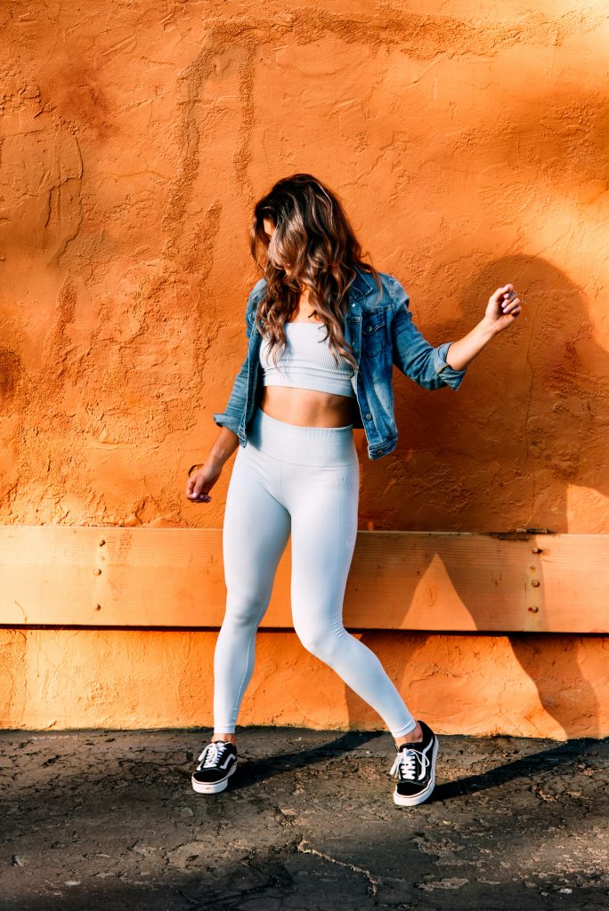 a model wearing the athleisure style with a denim jacket