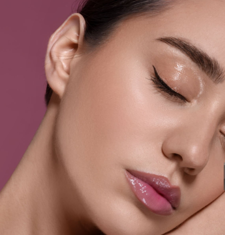 a lady with dewy wearing a bold liner make up