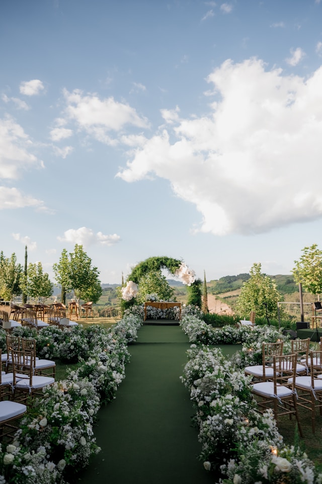 Wedding photo backdrop with greenery and floral accents.