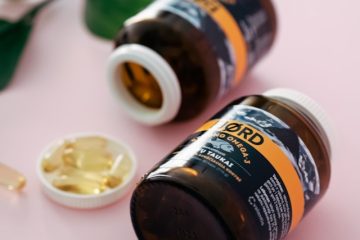 Assorted vitamins and supplements arranged on a table representing essential nutrients for women’s health.