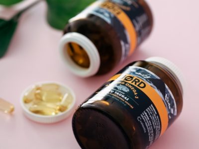 Assorted vitamins and supplements arranged on a table representing essential nutrients for women’s health.