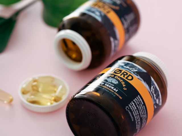 Assorted vitamins and supplements arranged on a table representing essential nutrients for women’s health.