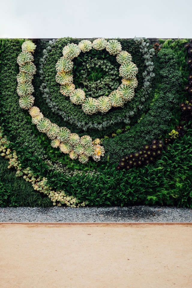 Wedding photo backdrop with greenery and floral accents.