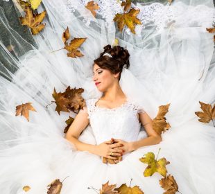 a lady lying on her wedding dress