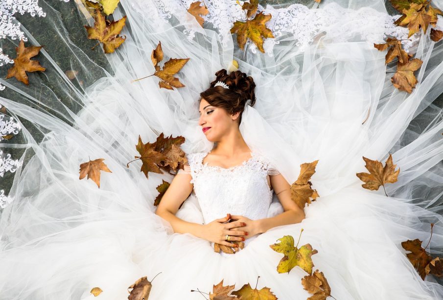a lady lying on her wedding dress
