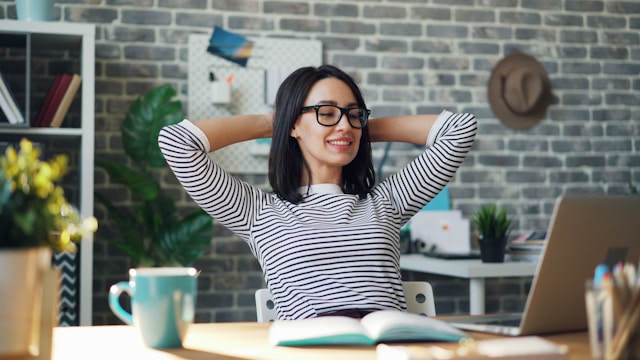 Person working at a desk with a notebook, laptop, and morning light, representing daily productivity habits, focused work routines, and structured time management.